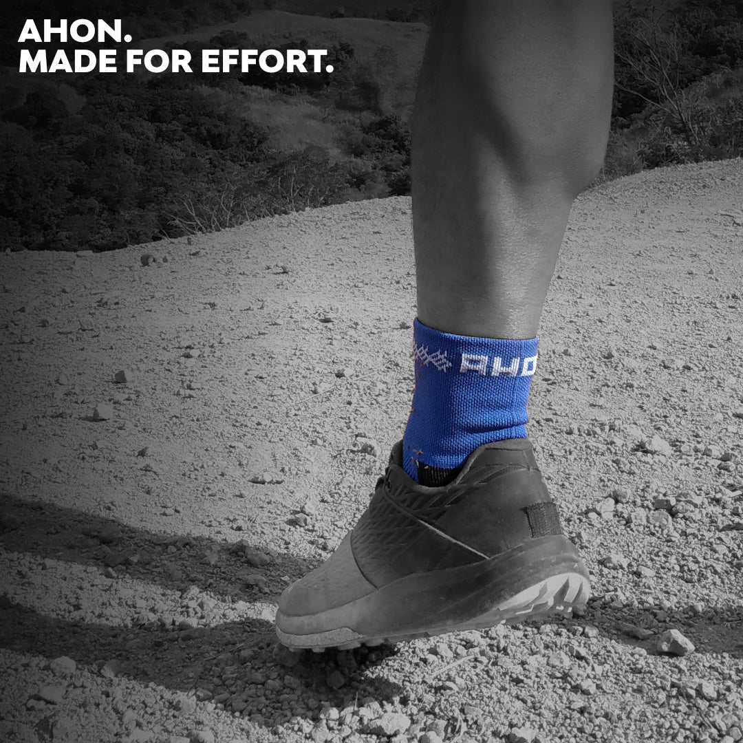 Ahon Trail Running Socks in blue worn during a trail run on rocky terrain