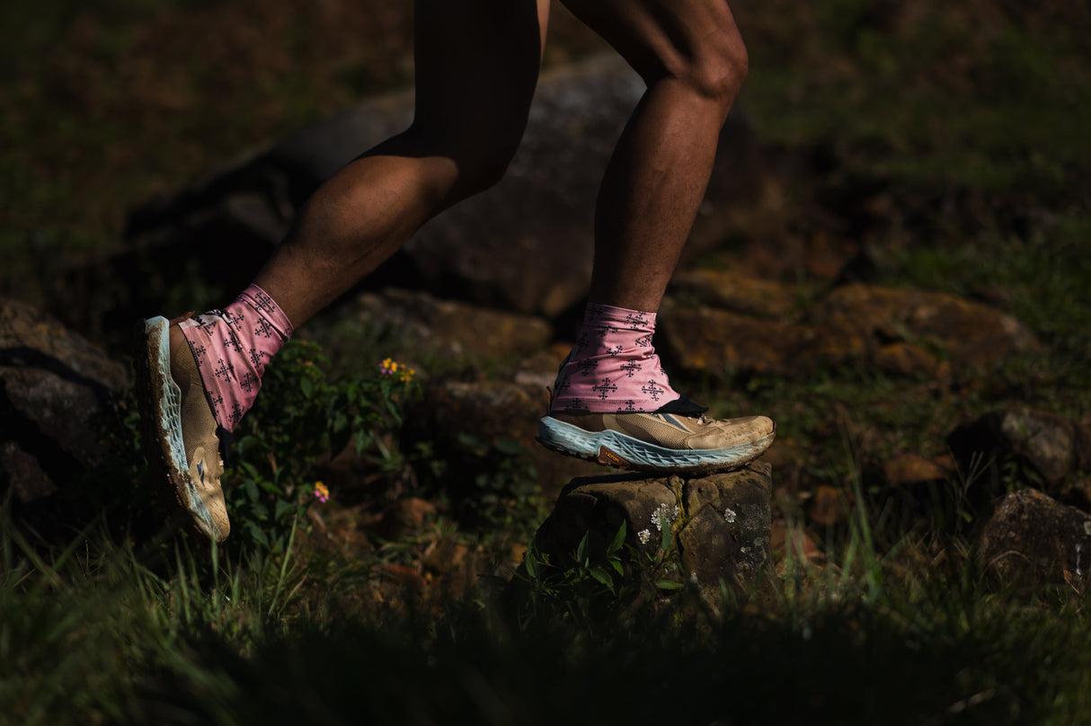 Close-up of a runner wearing Ahon’s Apo 1 Trail Running Gaiters in pink, shielding trail shoes from rocks and debris.