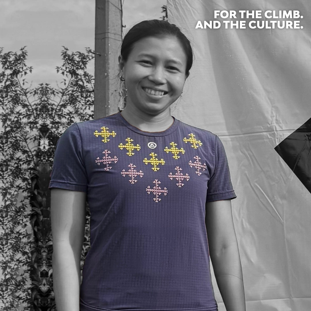 Woman wearing Ahon’s Apo Super Light Shirt in dark purple, smiling after a trail run