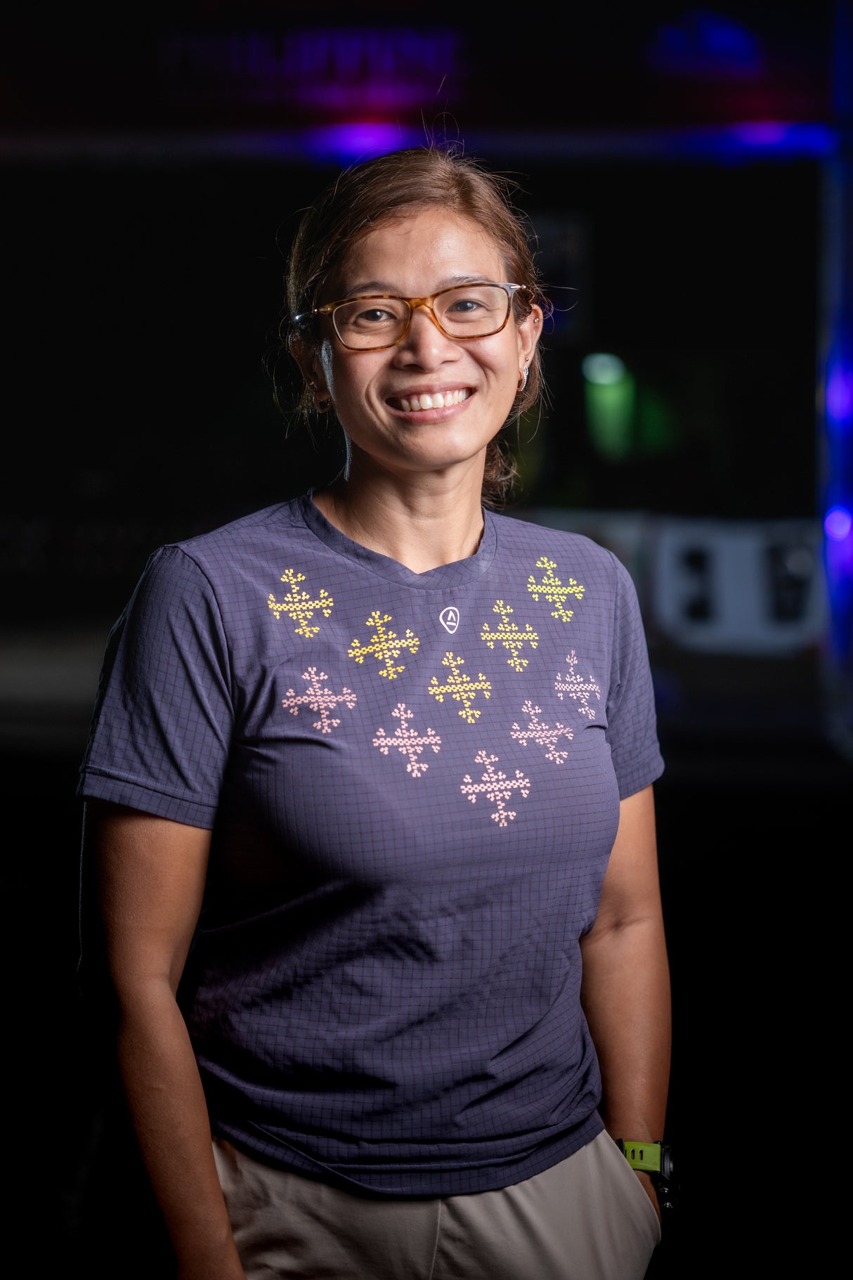 Woman wearing Ahon’s Apo Super Light Shirt in dark purple, smiling