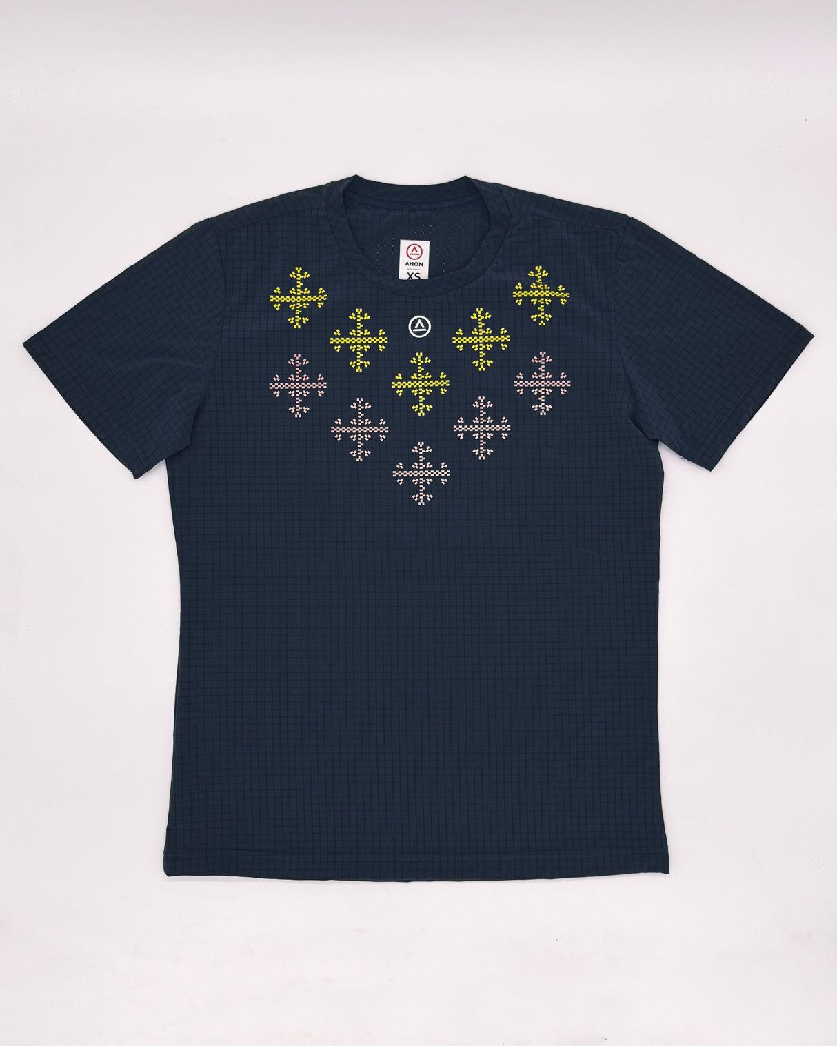 Flat lay of the Apo Super Light Shirt showing traditional-weaving-inspired design on chest