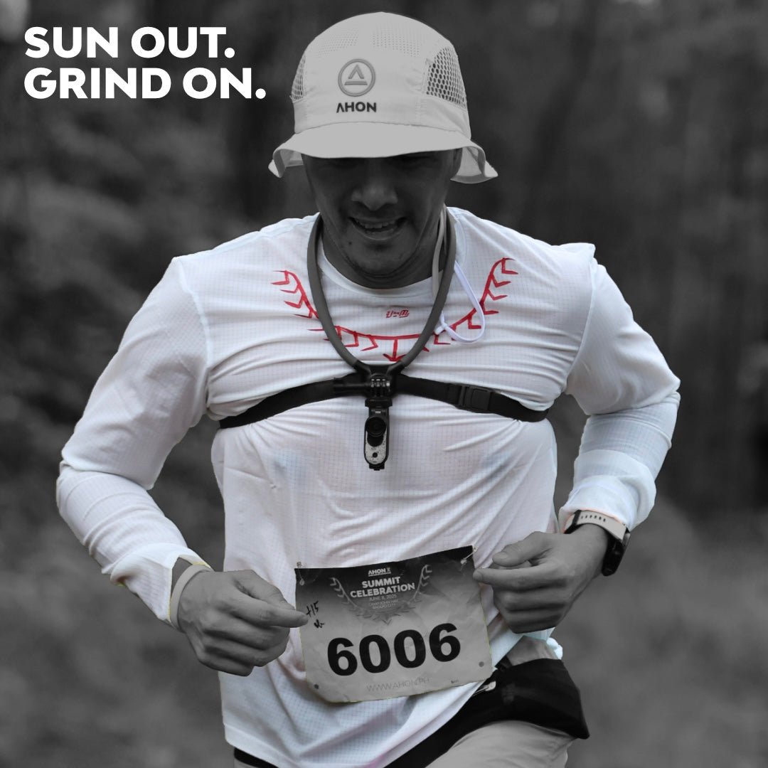 Trail runner wearing Koling Super Light LS Shirt in white with Ahon bucket hat, mid-stride during race