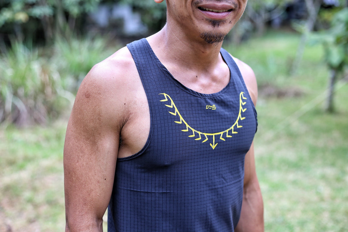 Close-up of lightweight mesh texture and yellow detail on Ahon singlet