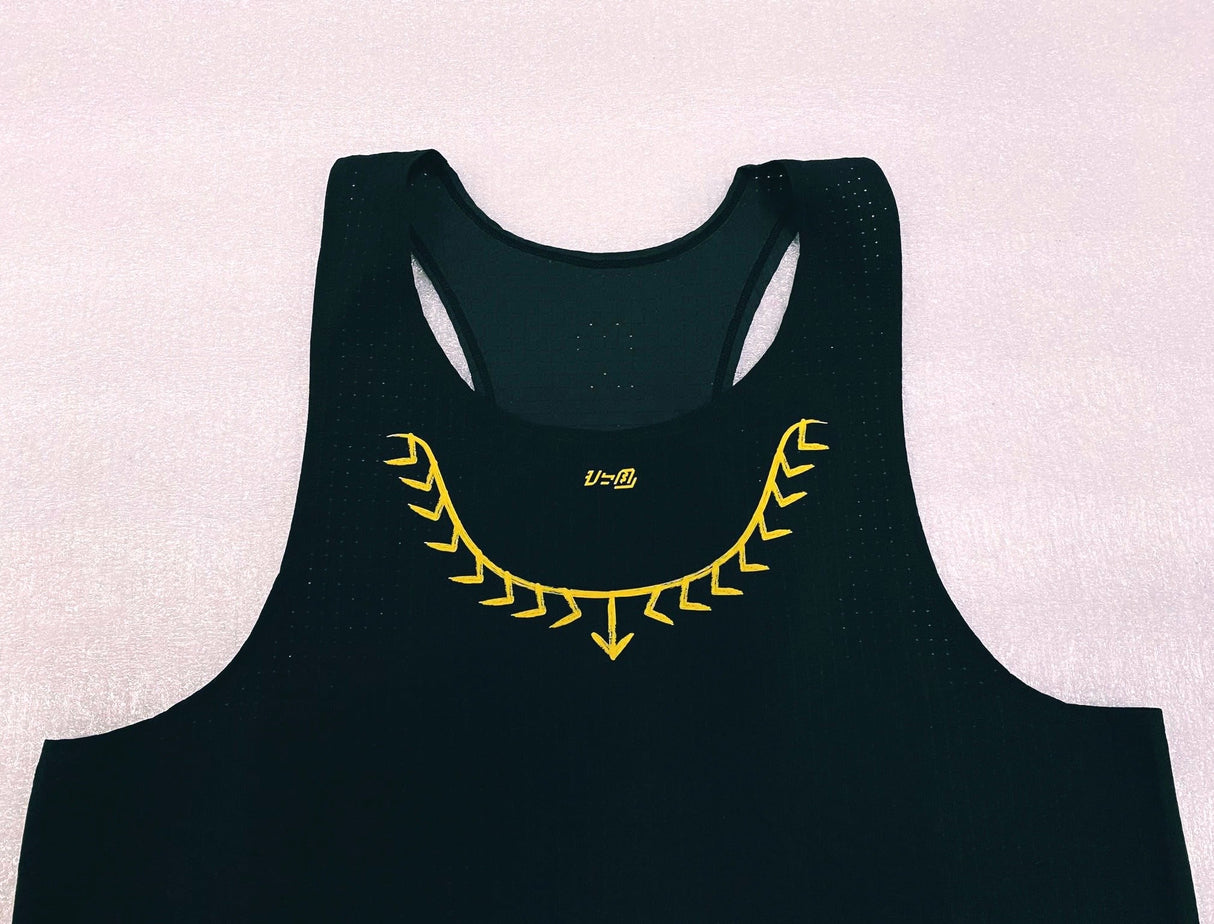 Close-up of lightweight mesh texture and yellow detail on Ahon singlet