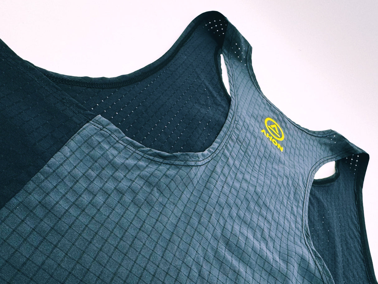 Close-up of lightweight mesh texture and yellow detail on Ahon Super Light singlet