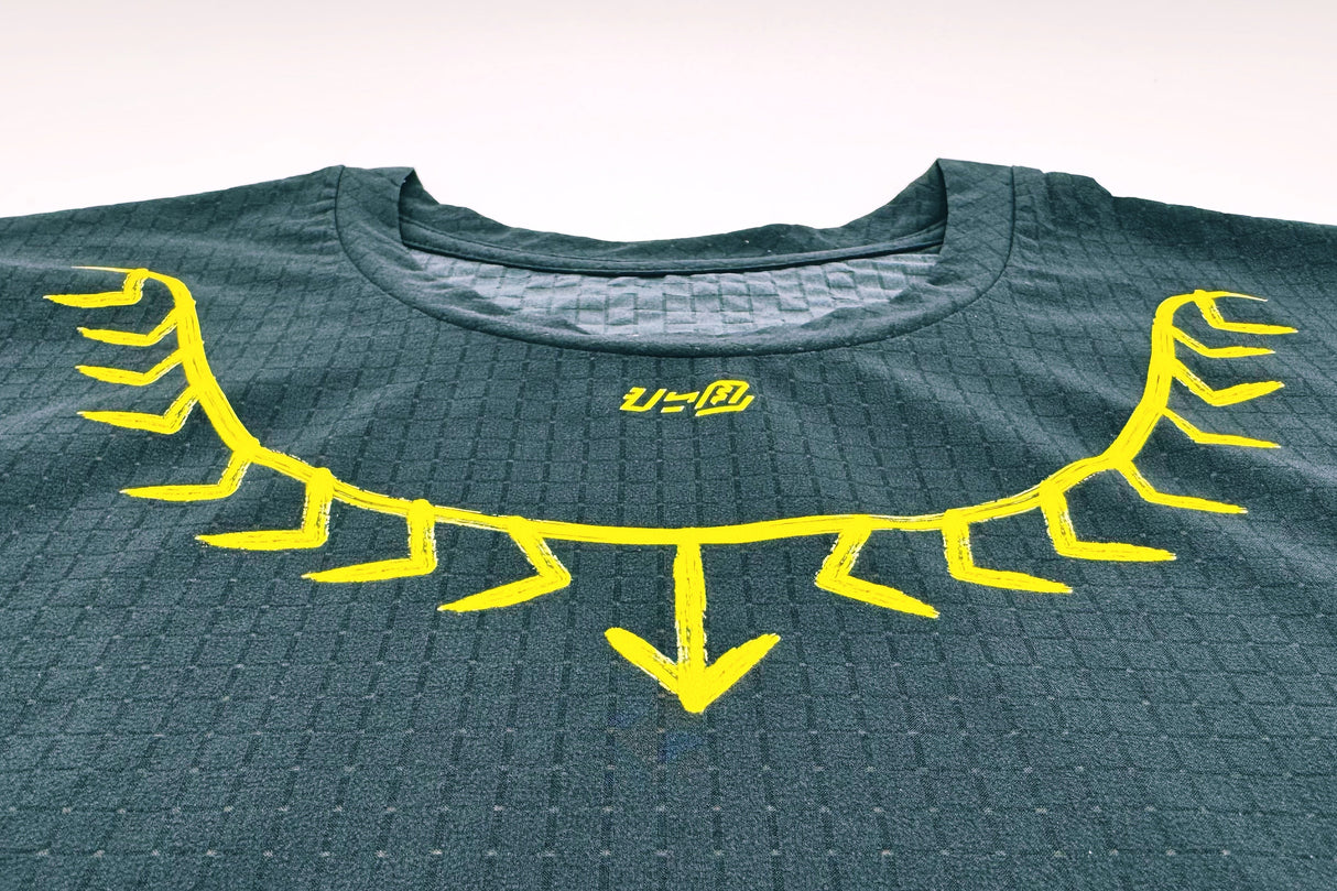 Detailed shot of tattoo-inspired yellow neck graphic on the Koling Super Light SS Shirt by Ahon