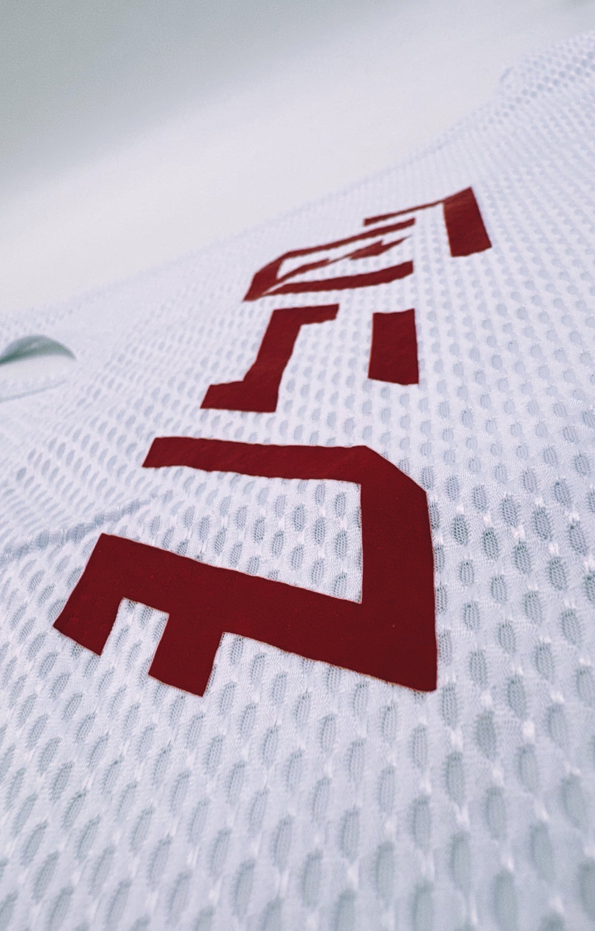 Close-up of red Baybayin-style logo on the KSU Singlet 2