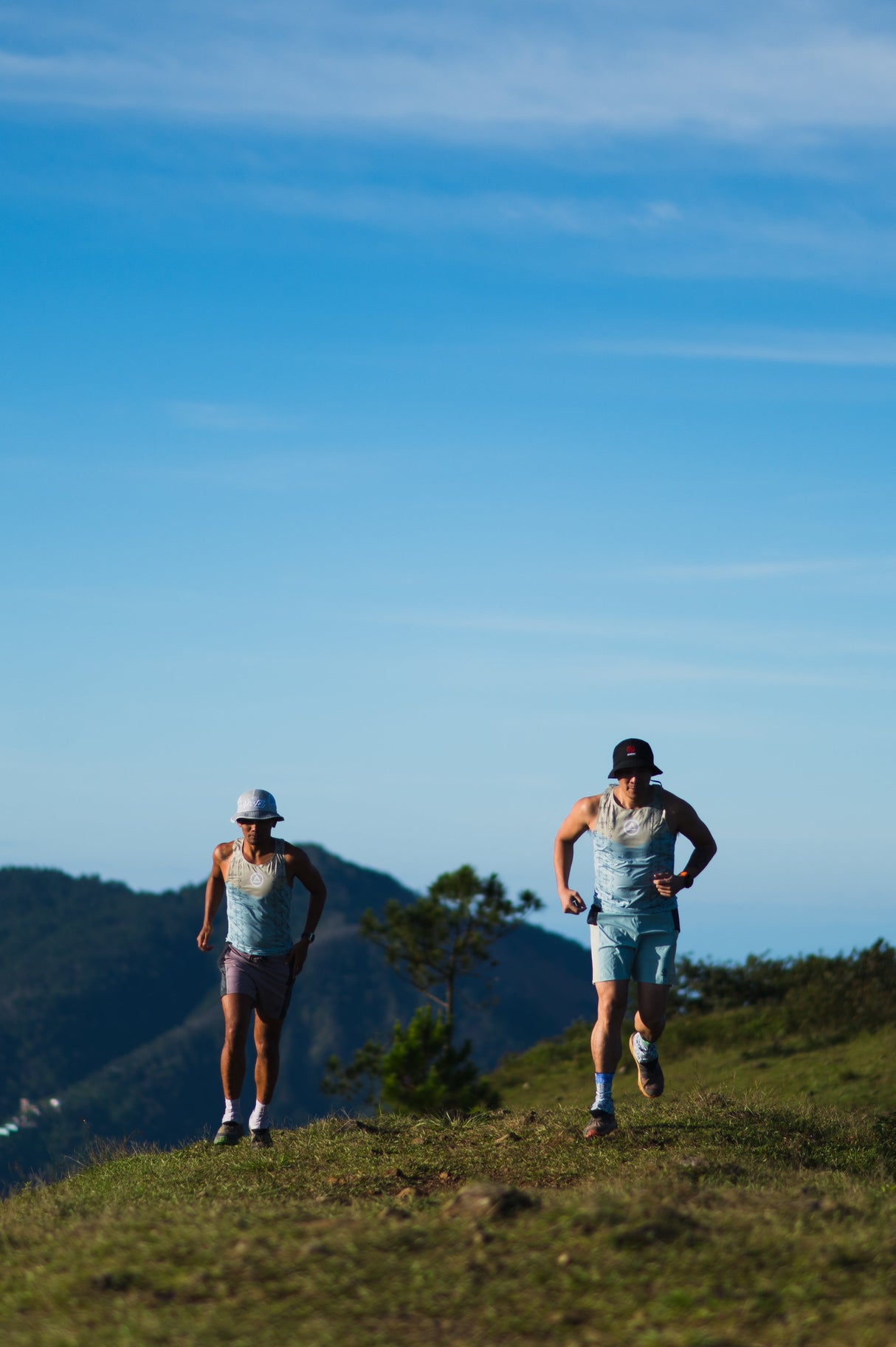 trail runners on a ridge wearing Singlet Pro (colorway 2)