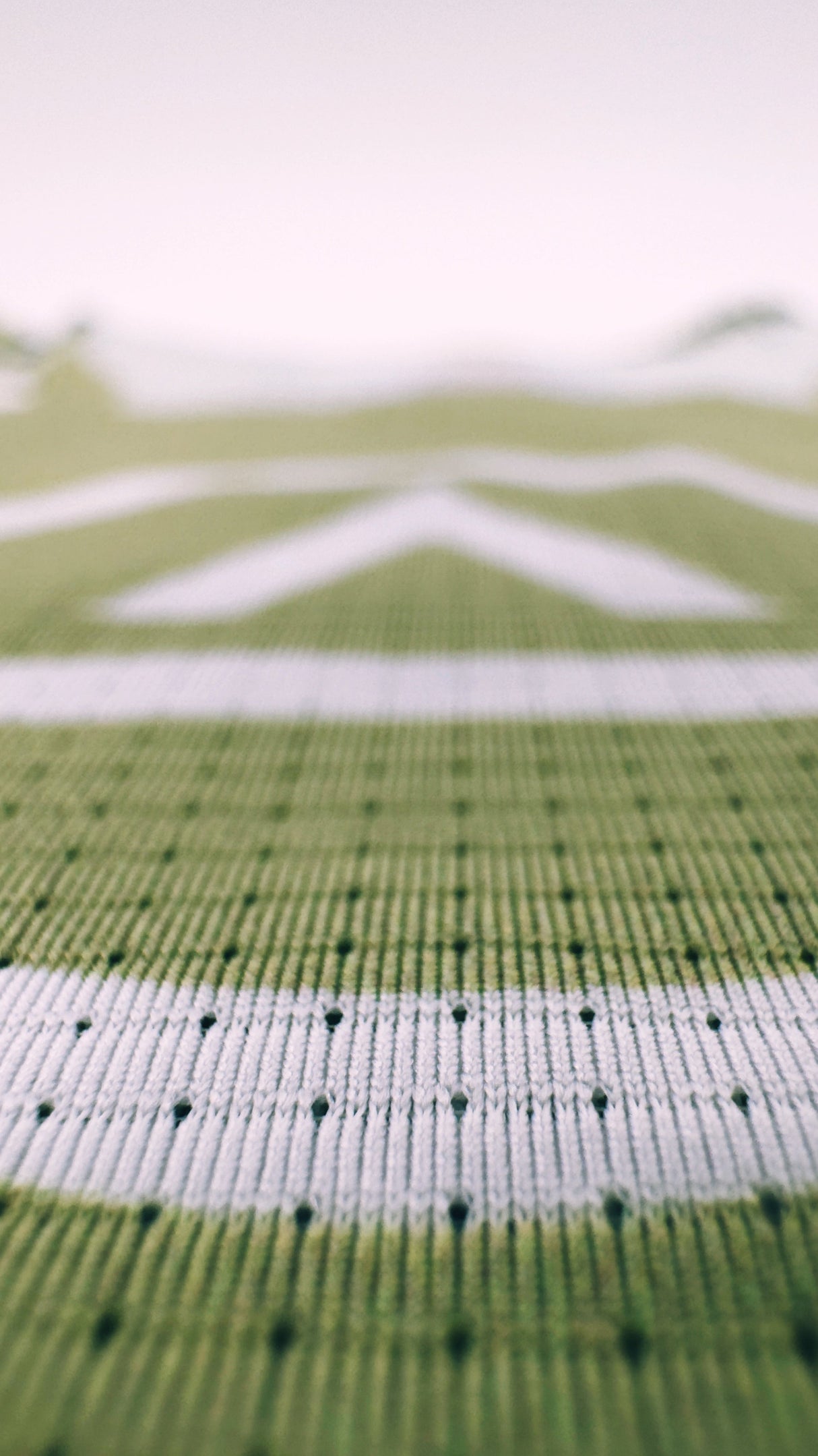 Zoomed detail of Singlet Pro Colorway 2 fabric showing trail-ready texture and indigenous-inspired print