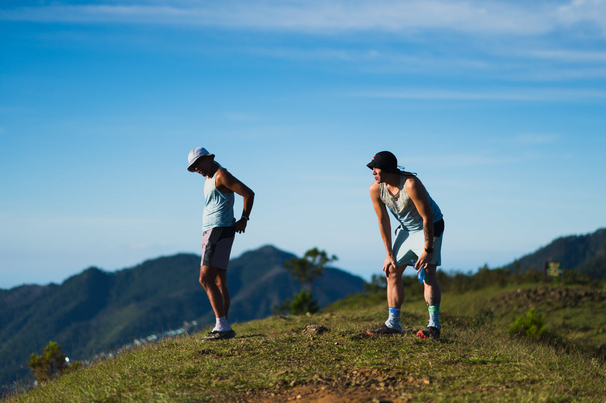 trail runners on a ridge wearing Singlet Pro (colorway 2)
