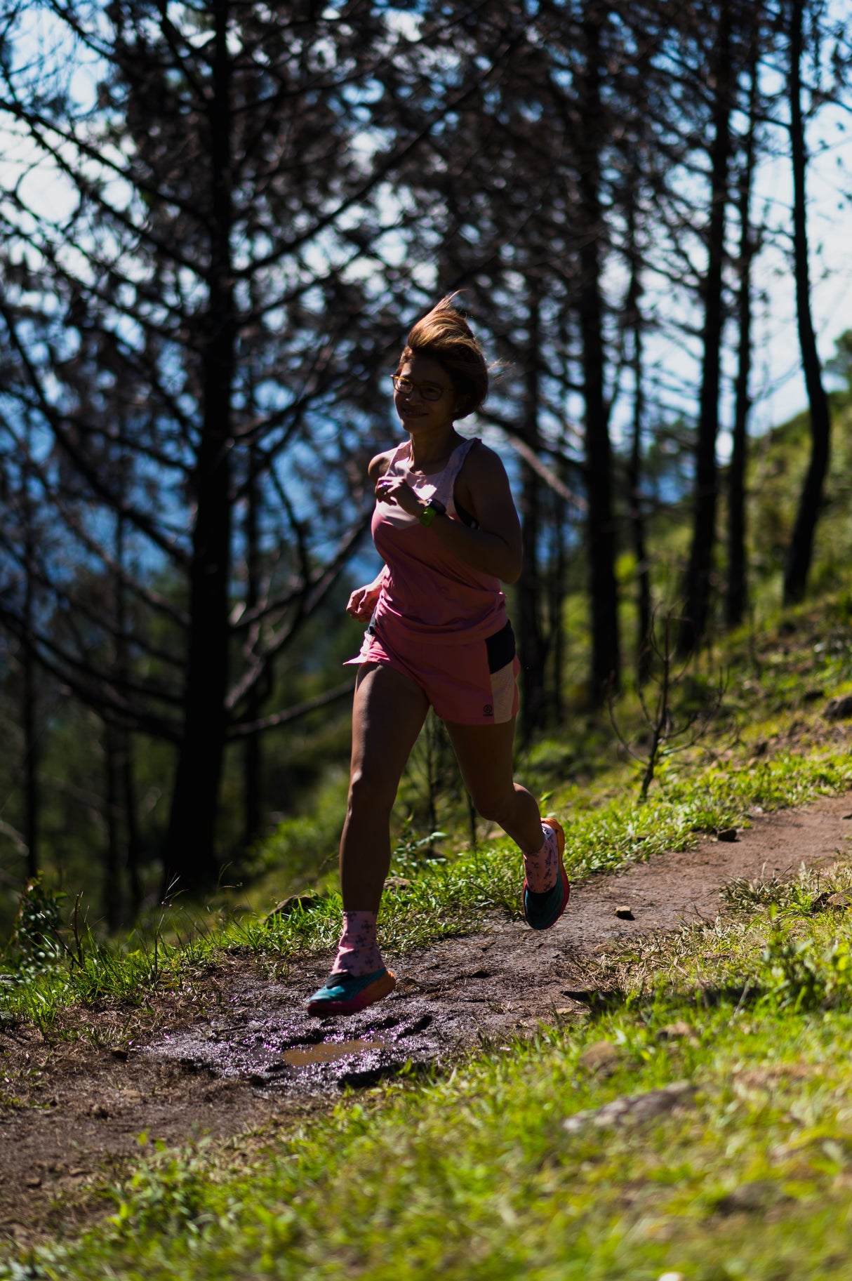 female trail runner running in Ahon Trail Shorts Pro, mid-stride