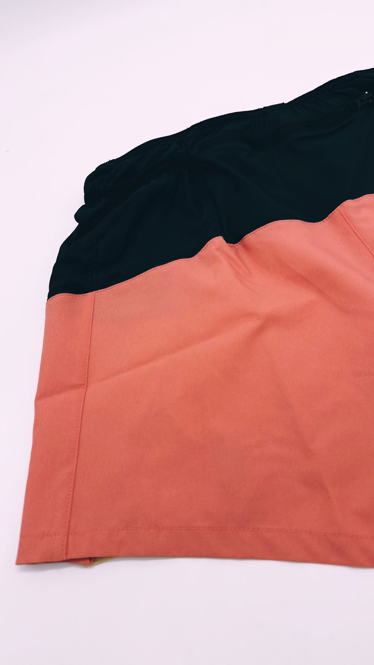 Flatlay of Ahon Trail Shorts Pro showing rear zip pocket and inner waistband stitching