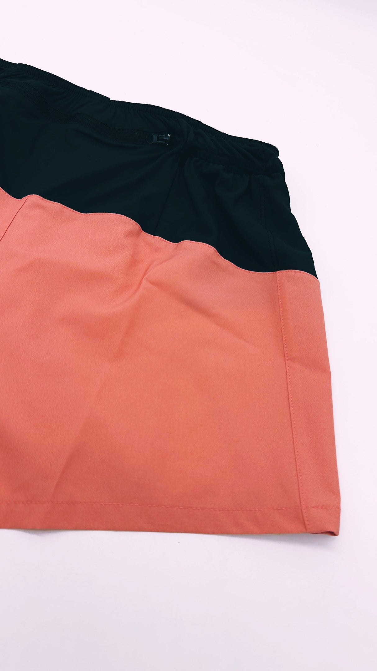 Flatlay of Ahon Trail Shorts Pro showing rear zip pocket and inner waistband stitching