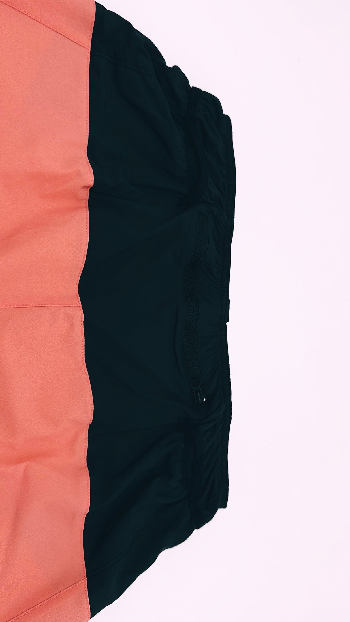 Flatlay of Ahon Trail Shorts Pro showing rear zip pocket and inner waistband stitching