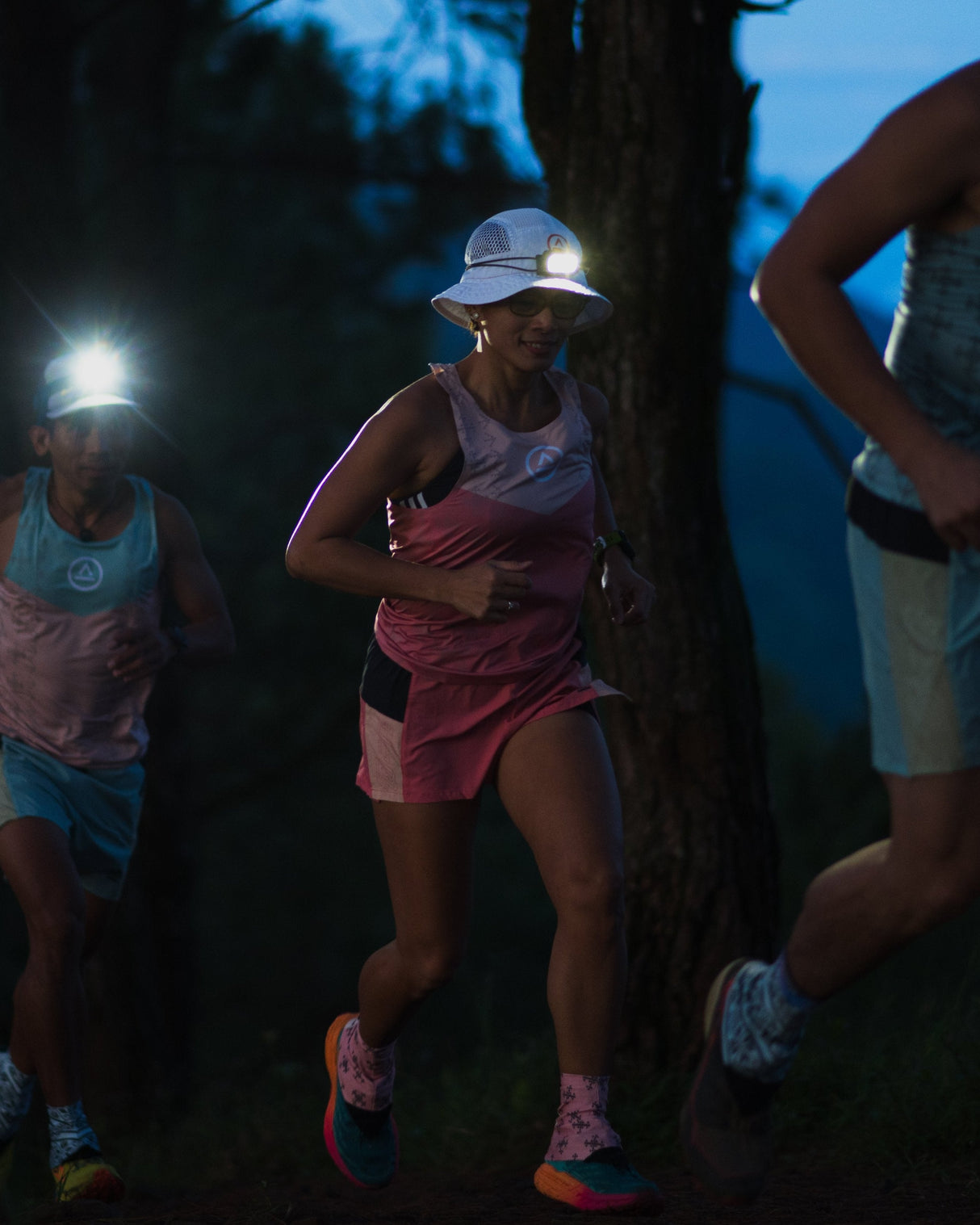 female trail runner running in Ahon Trail Shorts Pro (colorway 1) 3 - inch inseam