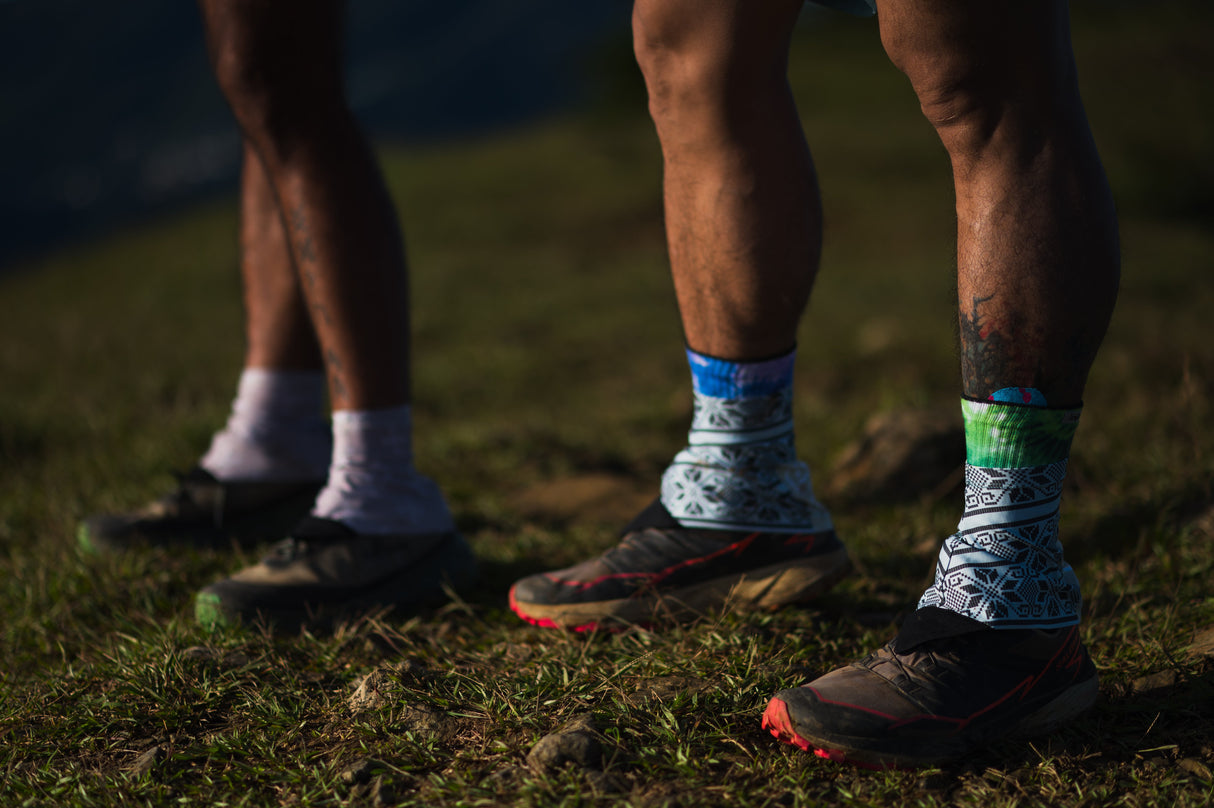 Group of trail runners climbing a forest trail, all wearing Ahon gaiters and shoes