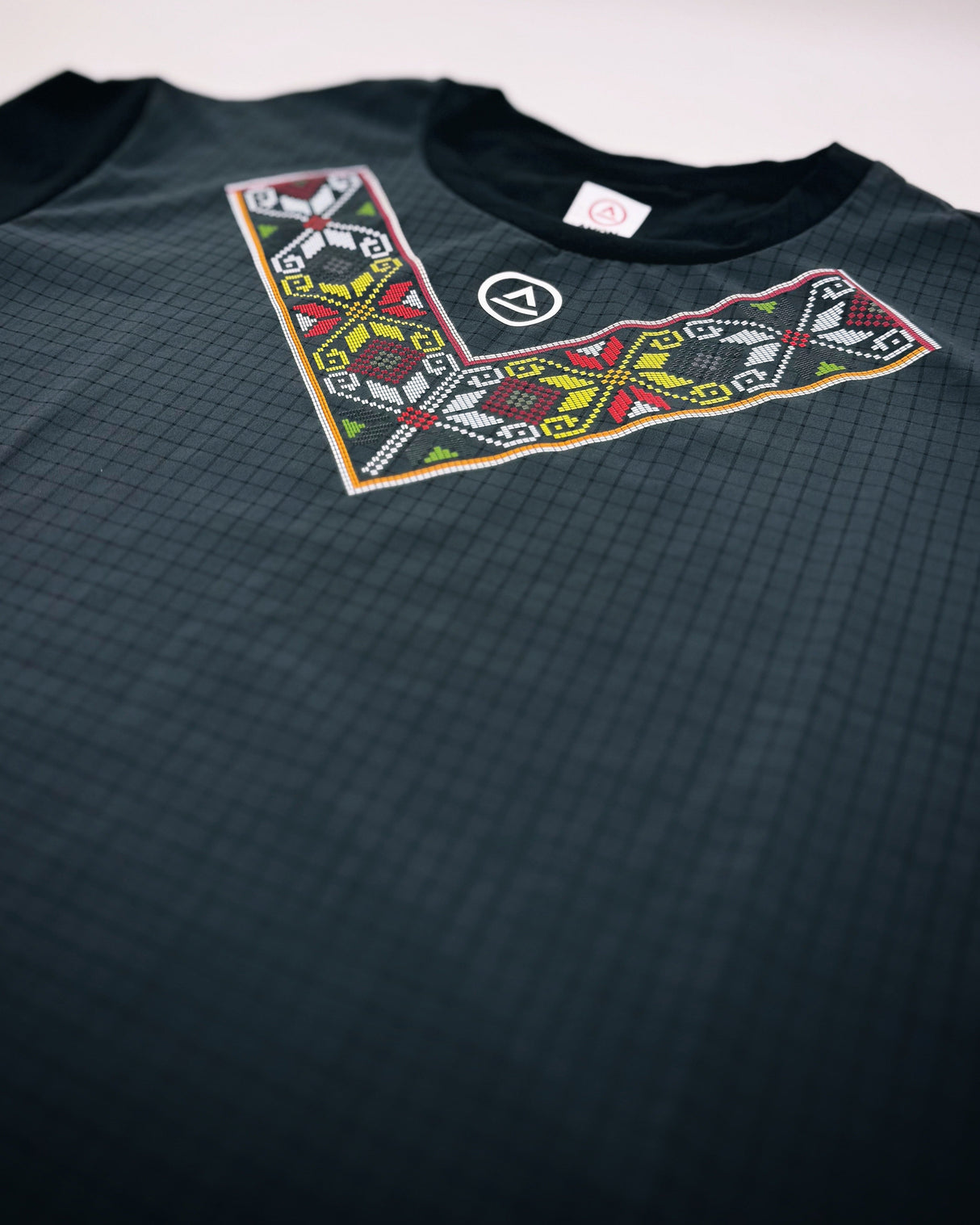 Close-up of Super Light fabric and chest print on Uleyan shirt, highlighting breathable texture