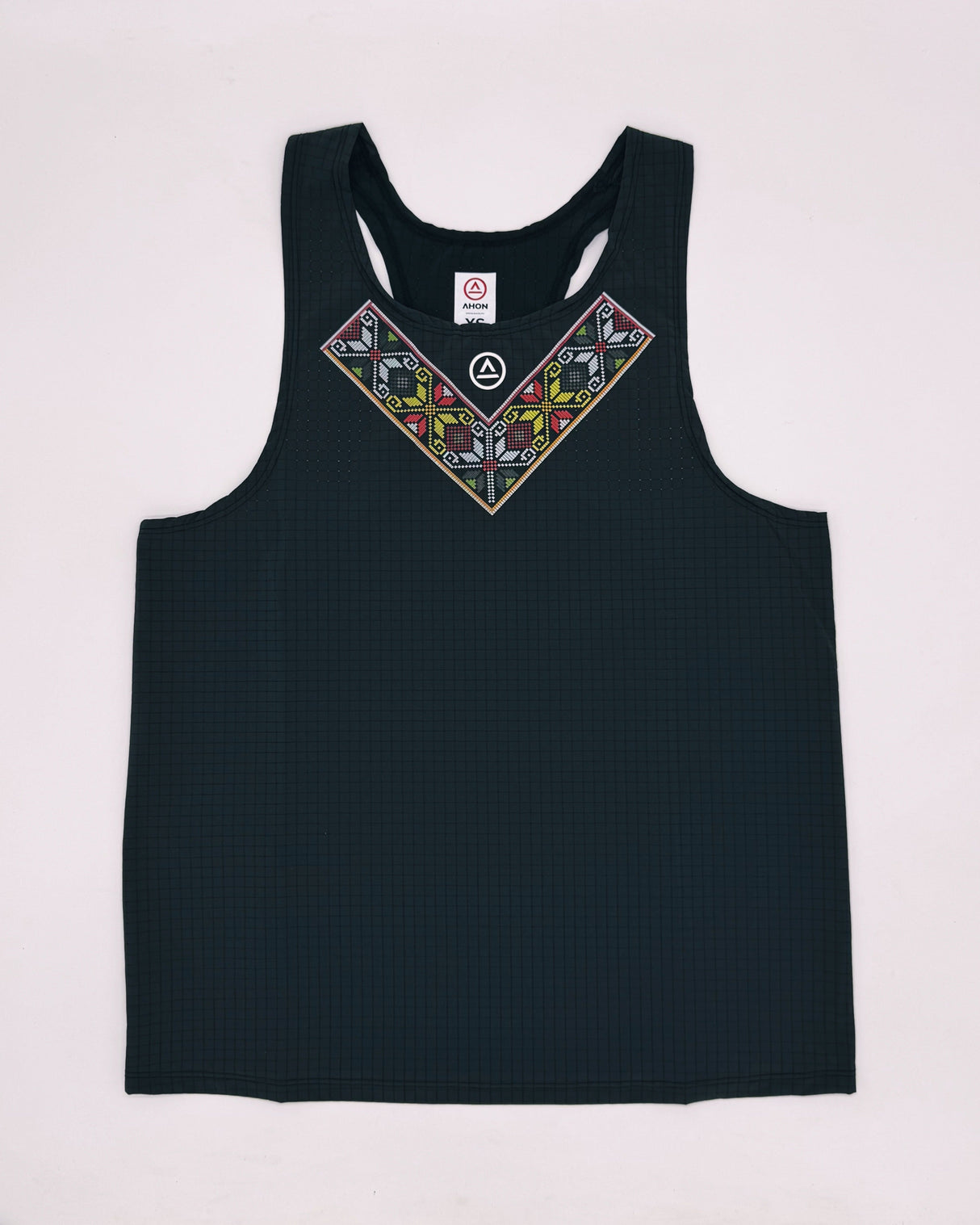Studio flatlay of ULEYAN Super Light Singlet in dark gray with traditional-inspired front pattern
