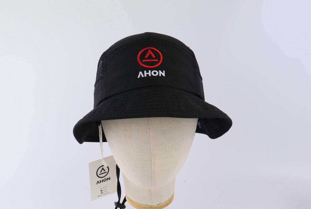 Close-up of logo embroidery on the black bucket hat