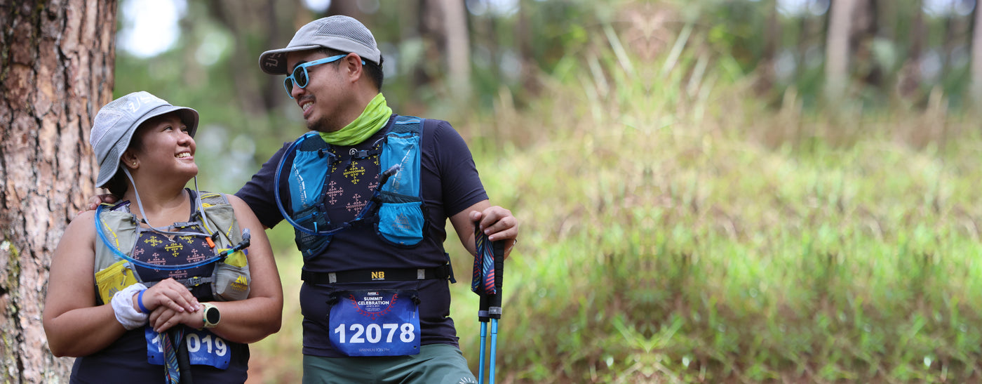 Male and female trail runner at Camp John Hay, wearing Ahon bucket hat and running cap.
