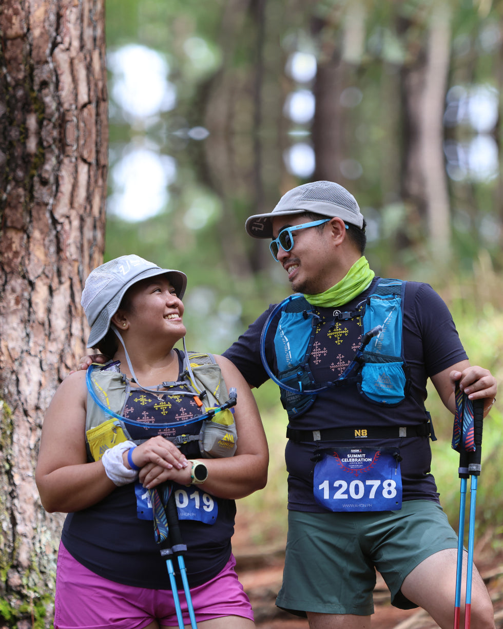 Married couple on the trails wearing Ahon Super Light shirt and singlet.