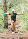 Female trail runner enjoying Philippine trails while wearing Super Light shirt and Ahon bucket hat.