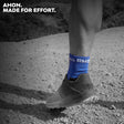 Ahon Trail Running Socks in blue worn during a trail run on rocky terrain