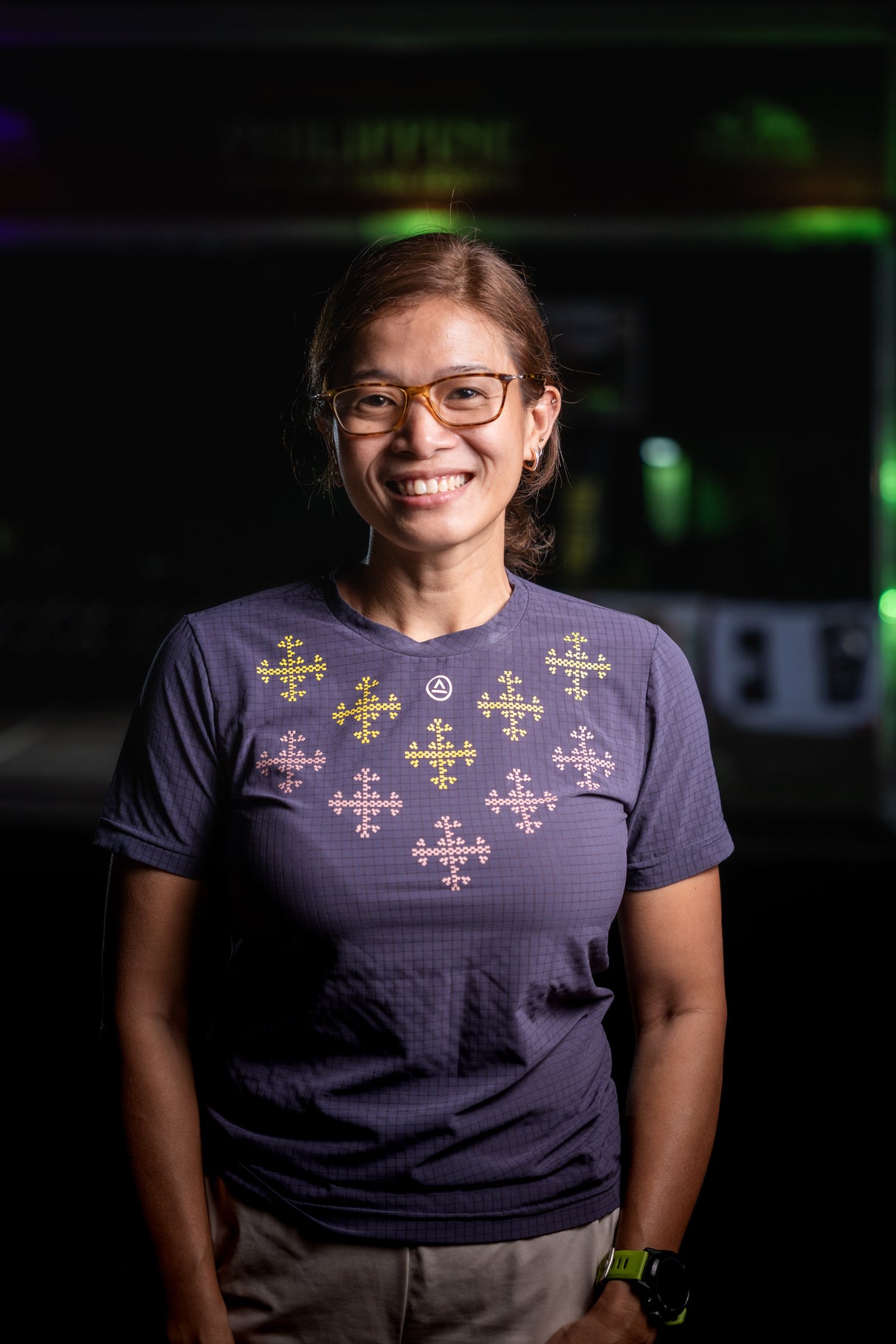 Woman wearing Ahon’s Apo Super Light Shirt in dark purple, smiling 