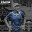 Male trail runner wearing Ahon’s Koling Super Light SS Shirt in black/gray with yellow detail during a mountain race.