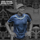 Male trail runner wearing Ahon’s Koling Super Light SS Shirt in black/gray with yellow detail during a mountain race.