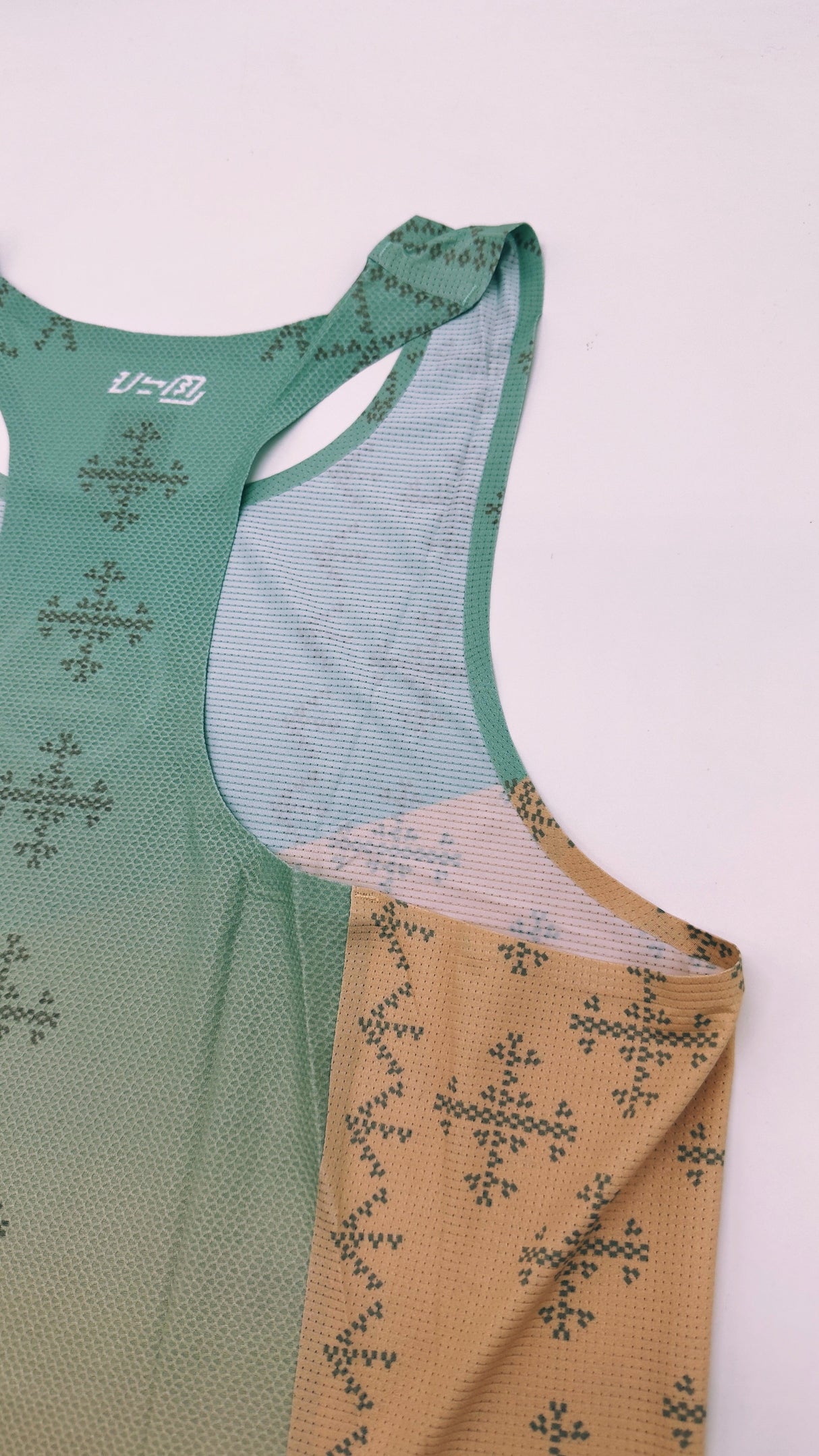 Singlet Pro flatlay – side profile showcasing armhole and fit