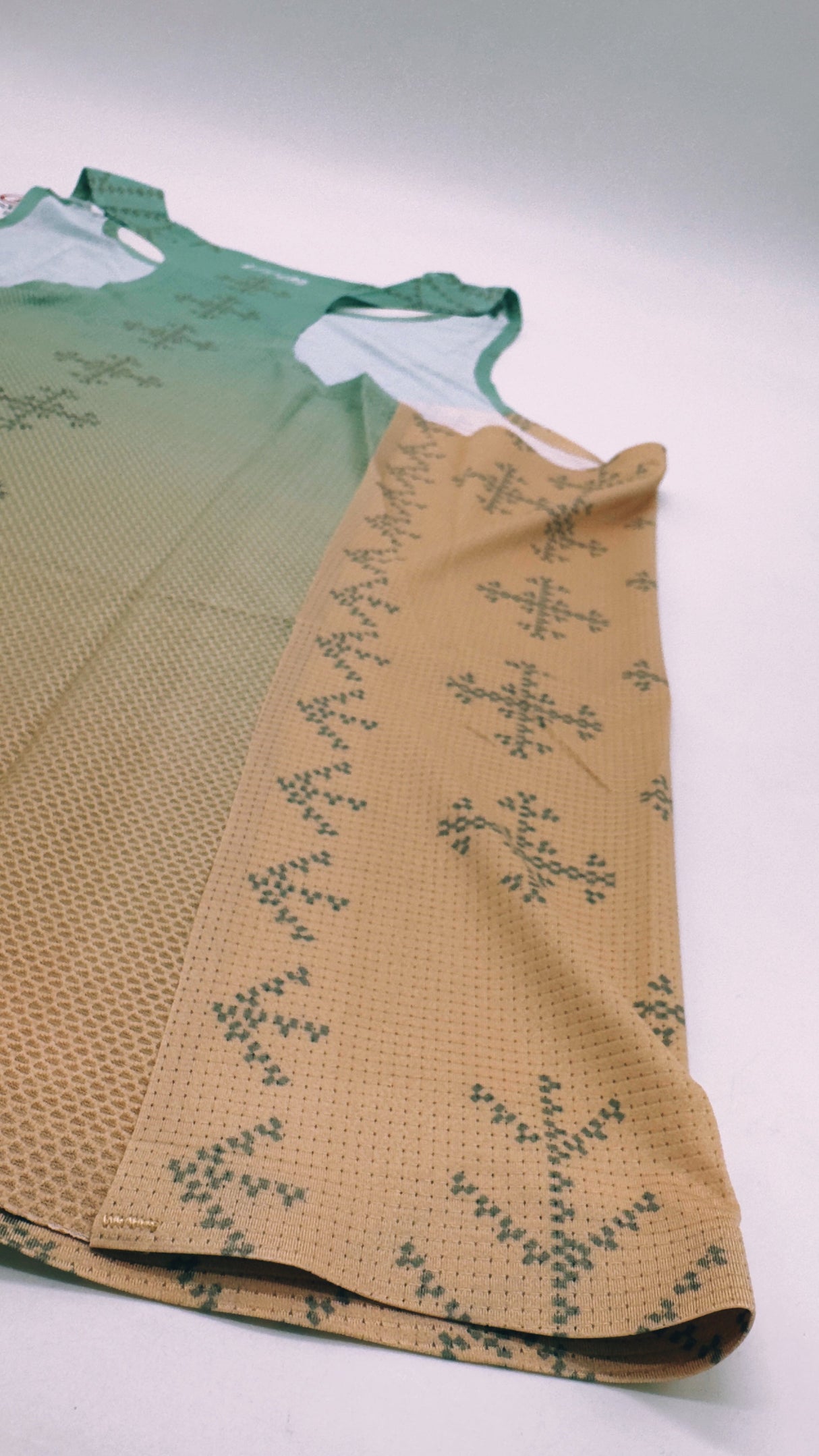 Singlet Pro flatlay – side profile showcasing armhole and fit