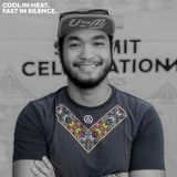 Male trail runner smiling while wearing the Uleyan Super Light SS Shirt in dark gray with colorful woven-inspired chest pattern